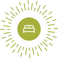 The image shows a bed icon inside a green circle with radiating lines around it, resembling rays or a sunburst pattern.